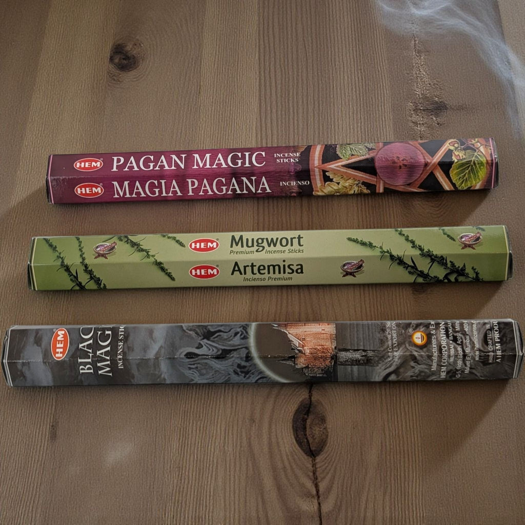 Three boxes of HEM incense sticks on a wooden surface available now at zen collection metaphysical store in barrie