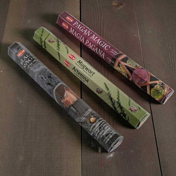 Three packages of incense sticks with labels on a wooden surface available at zen collection metaphysical store in barrie