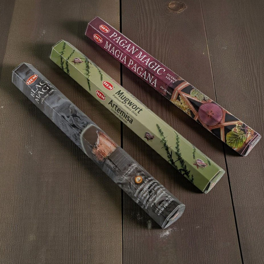 Three packages of incense sticks with labels on a wooden surface available at zen collection metaphysical store in barrie