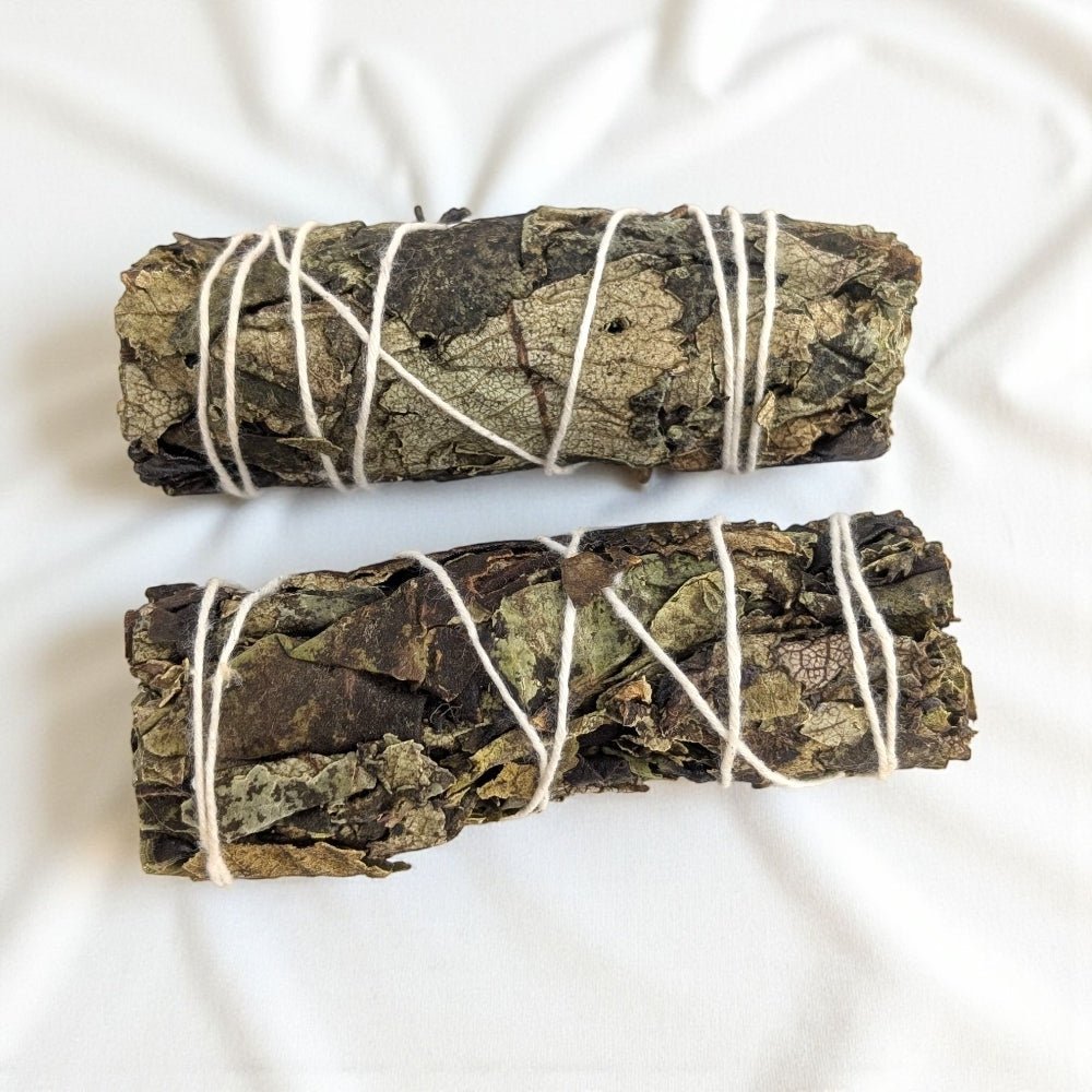 Two black sage smudge sticks tied with white string on a light background available at crystal and metaphysical store Barrie