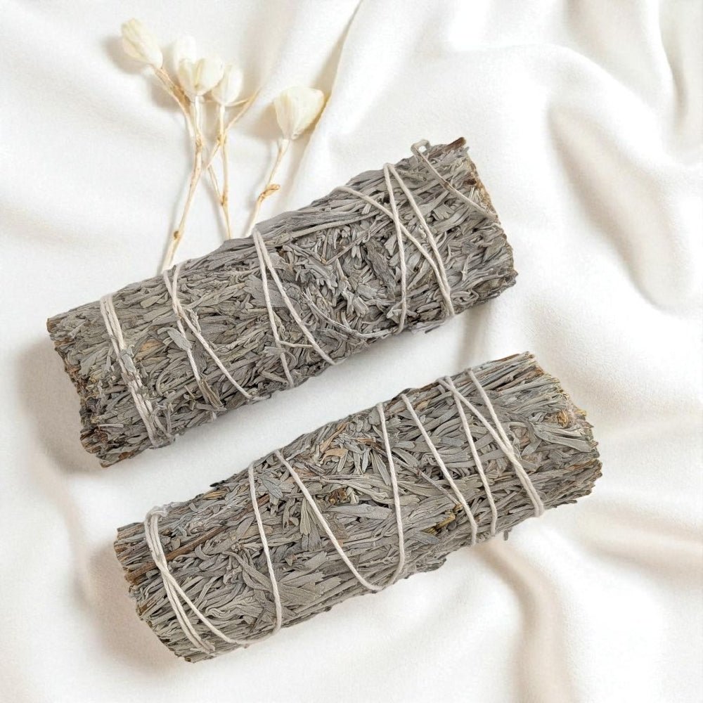 Two blue sage smudge sticks tied with string on a white background purchase now at zen collection metaphysical store in Barrie