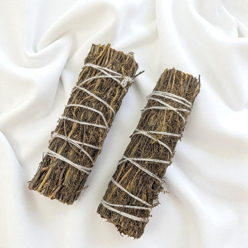 Two copal bundles tied with twine on a white fabric background available at  Barrie Crystal Store