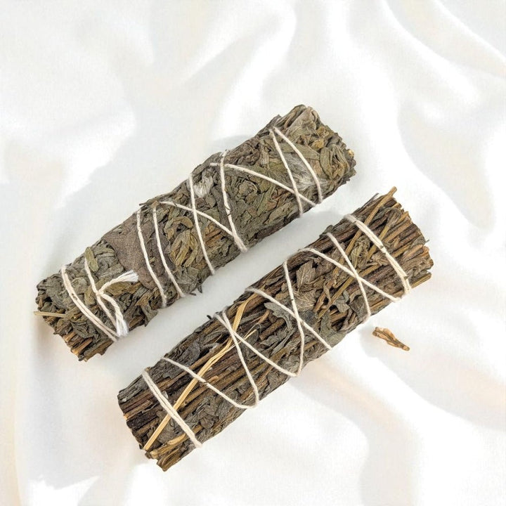 Two mugwort bundles tied with string on a white background available at Barrie Crystal Store