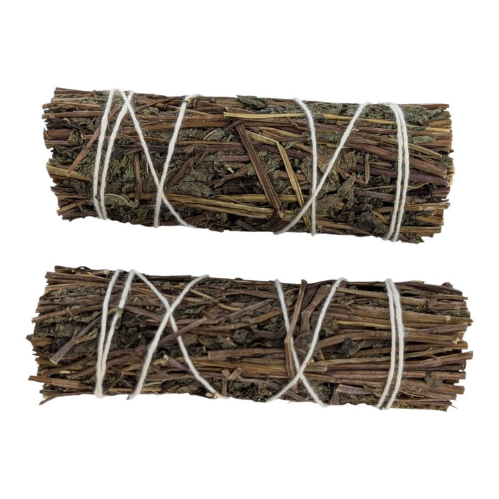 Two bundles of dried herbs tied with twine on a white background order now from crystal store in Barrie Ontario canada