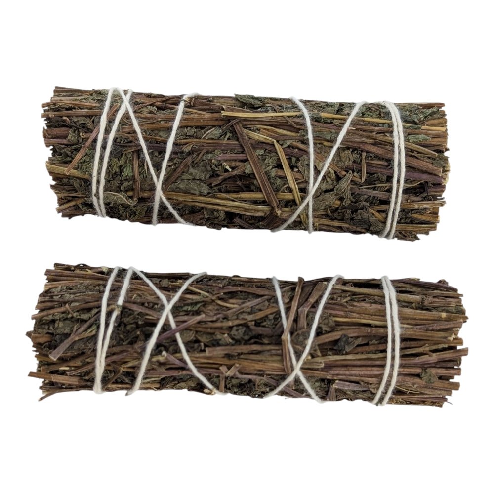 Two bundles of dried herbs tied with twine on a white background order now from crystal store in Barrie Ontario canada