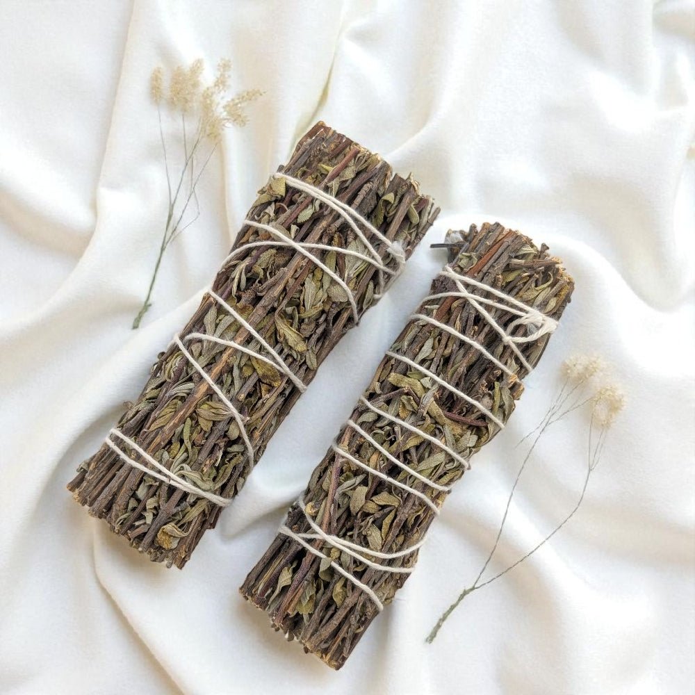 Two bundles of royal sage tied together on a white fabric background available at zen collection crystal store in barrie