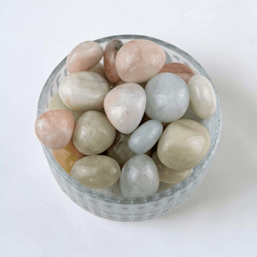 Morganite tumbled stones on white background