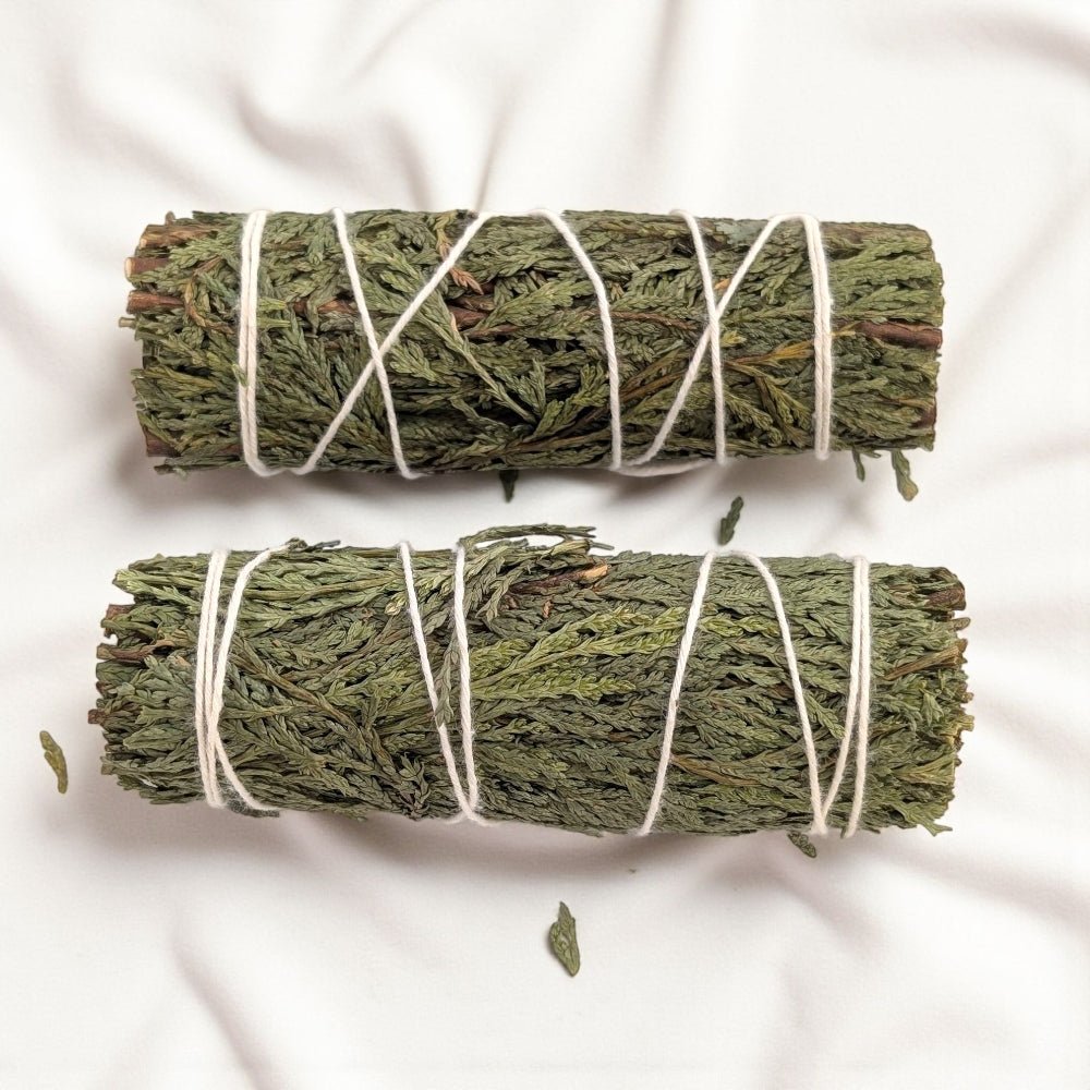 Two bundles of cedar tied with twine on a white background available at zen collection metaphysical store in barrie