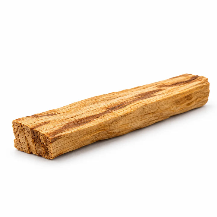 Close-up of a single unwrapped Palo Santo stick showing its natural wood grain on white.