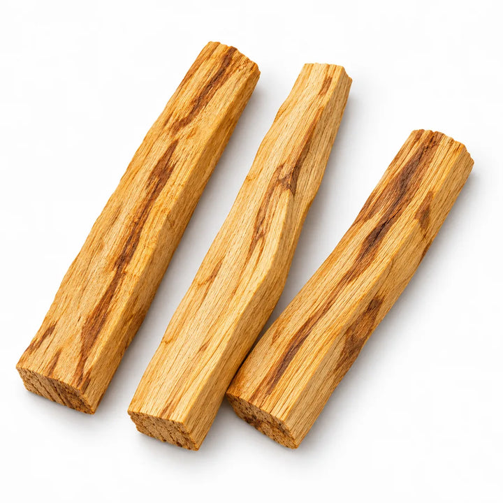 Three loose Palo Santo sticks arranged on white, showing natural variations in the wood; sold individually.