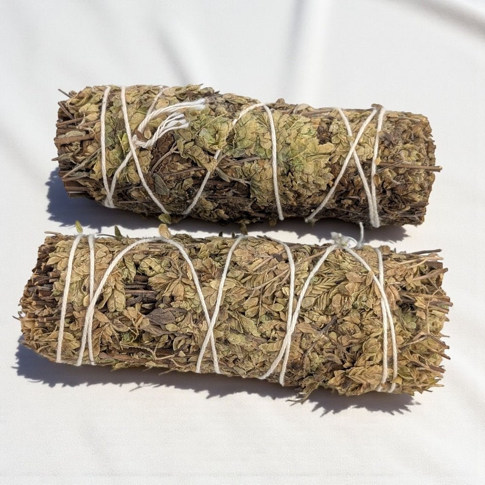 Two pure oregano bundle for cleansing and protection tied with twine on a white background available t barrie crystal store