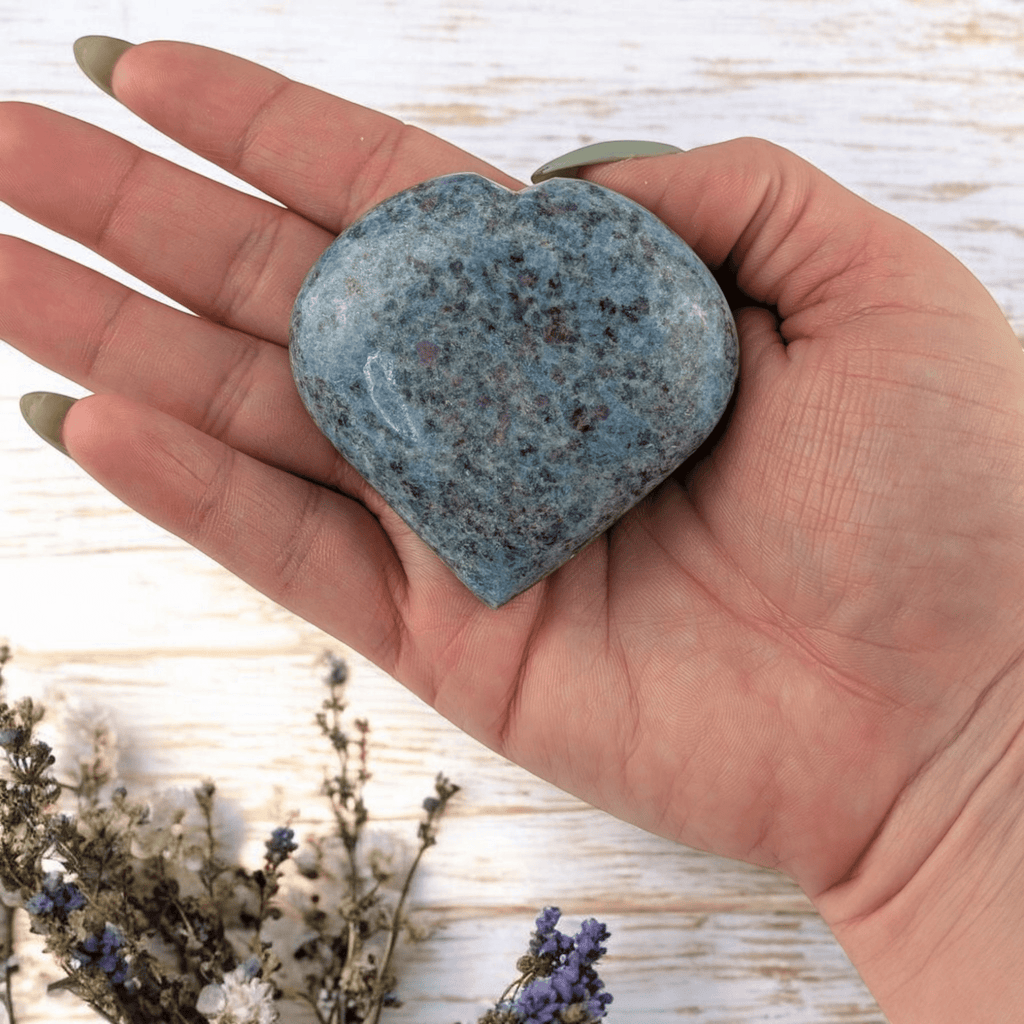 Blue and pink heart crystal on neutral background