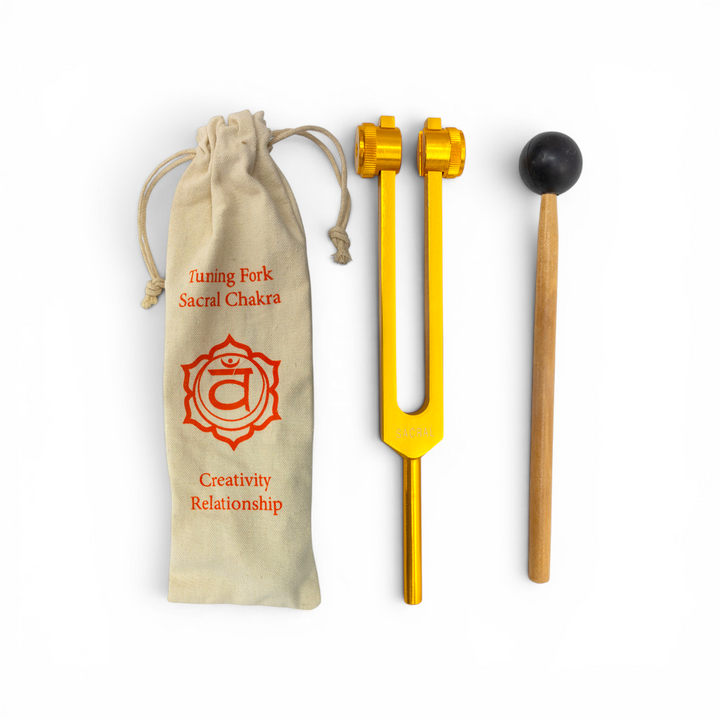 Gold aluminum Sacral Chakra tuning fork at 210.42 Hz with wooden mallet and linen drawstring pouch