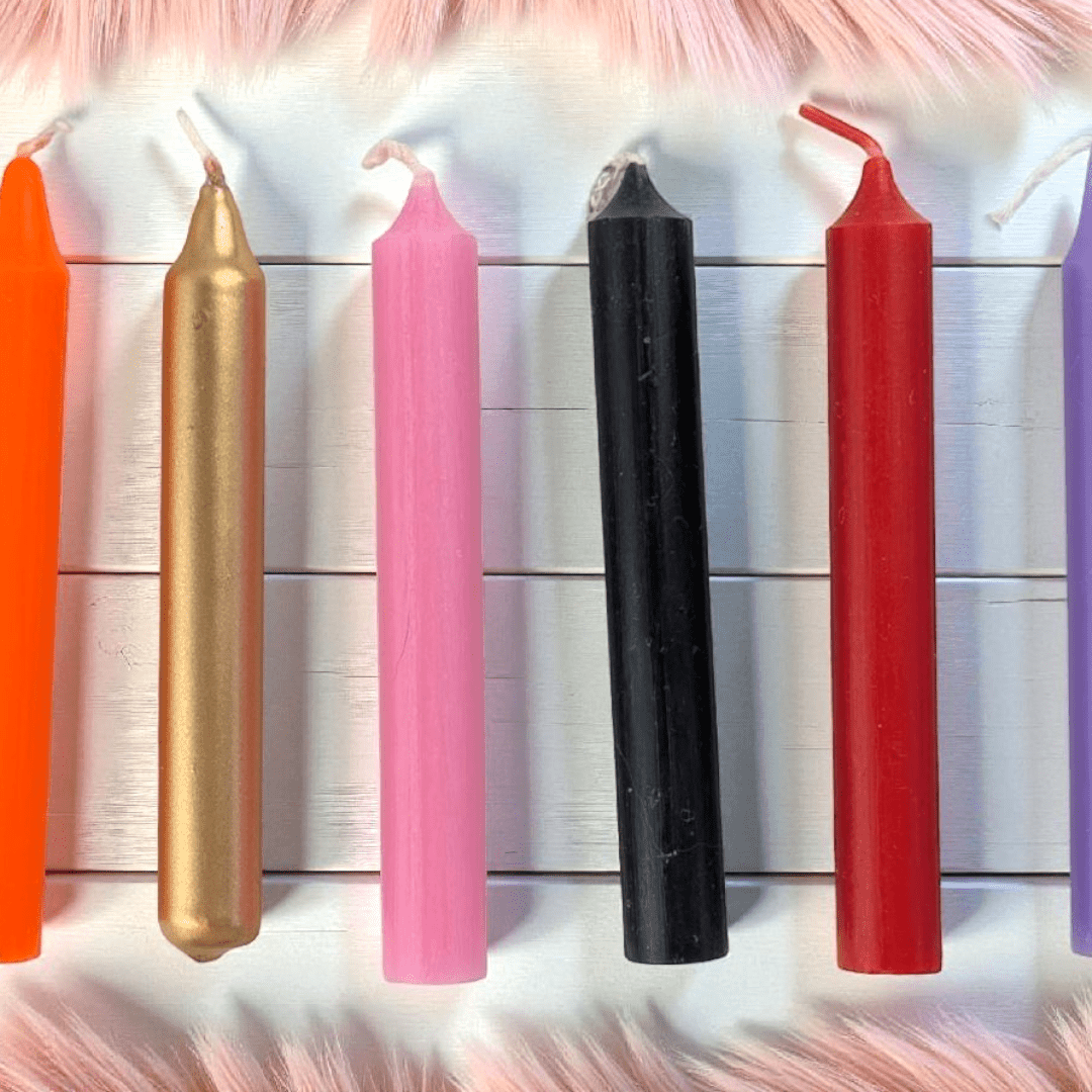 Colorful candles of various sizes on a textured surface available at zen collection crystal shop Barrie