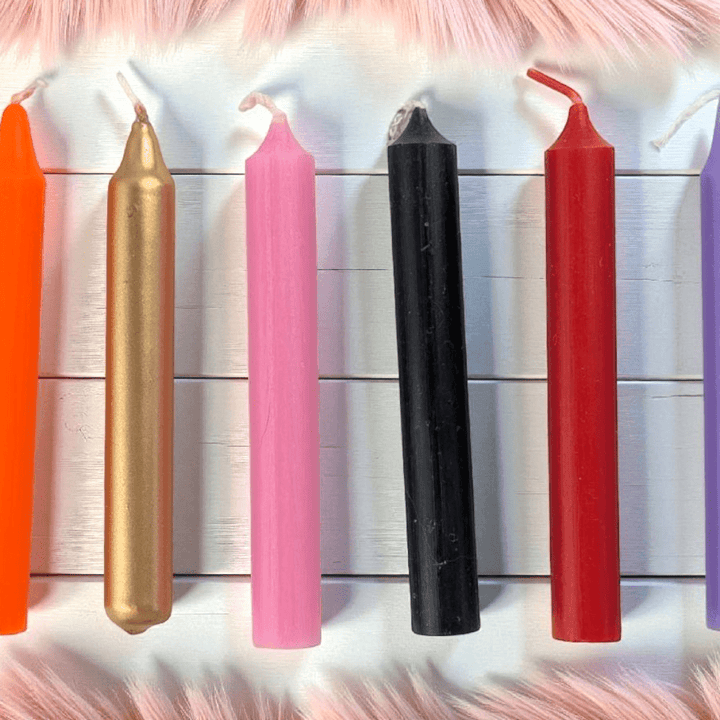 Colorful candles of various sizes on a textured surface available at zen collection crystal shop Barrie