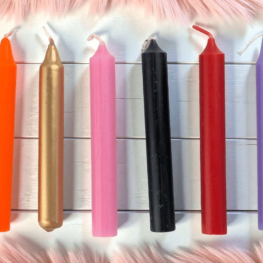 Colorful candles of various sizes on a textured surface available at zen collection crystal shop Barrie