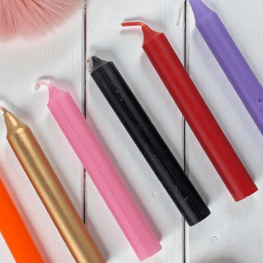 Colorful candles on a white wooden surface available at zen collection metaphysical store barrie