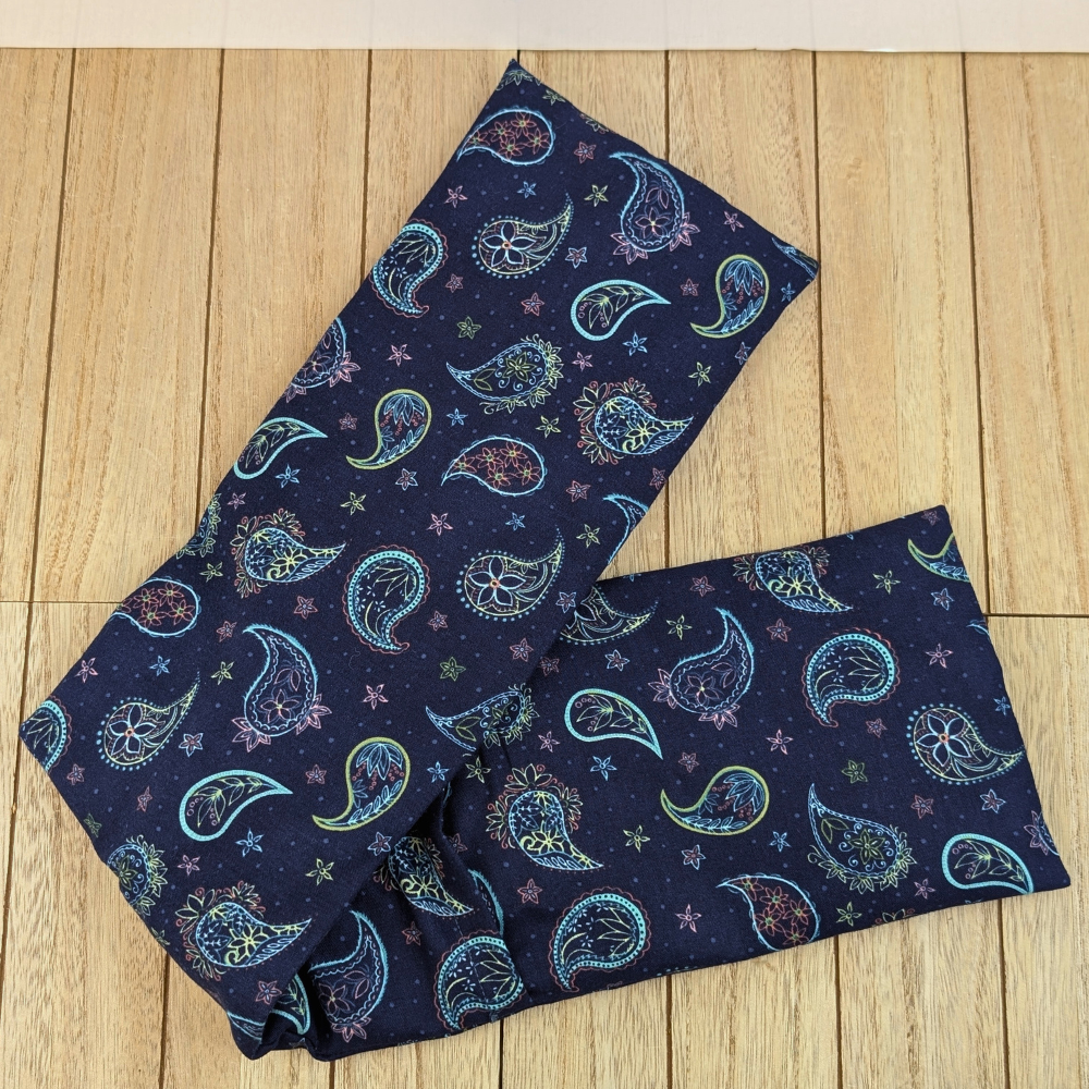 Weighted neck wrap in celestial-inspired paisley design