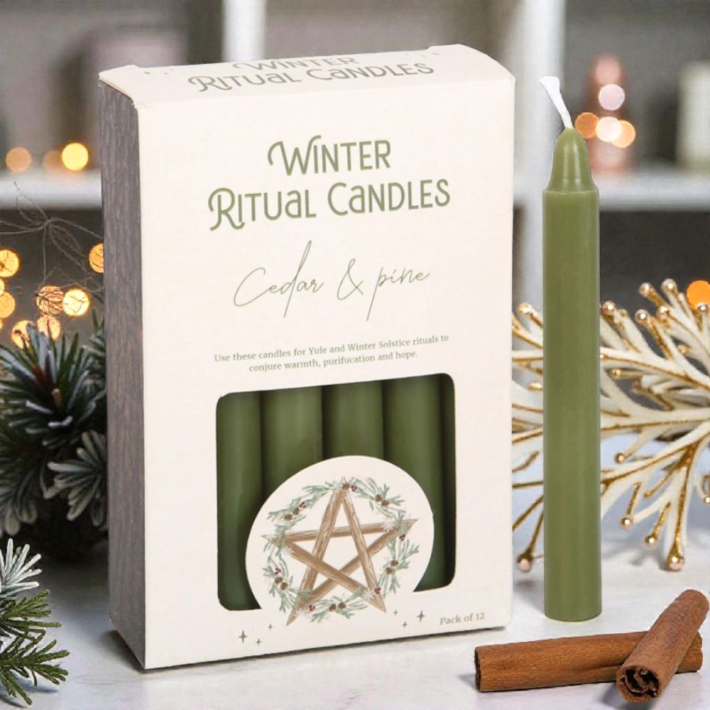 Packaging of 'Winter Ritual Candles' with a green candle and cinnamon sticks on a decorative background. Available at Zen Collection Crystal Stores Near me
