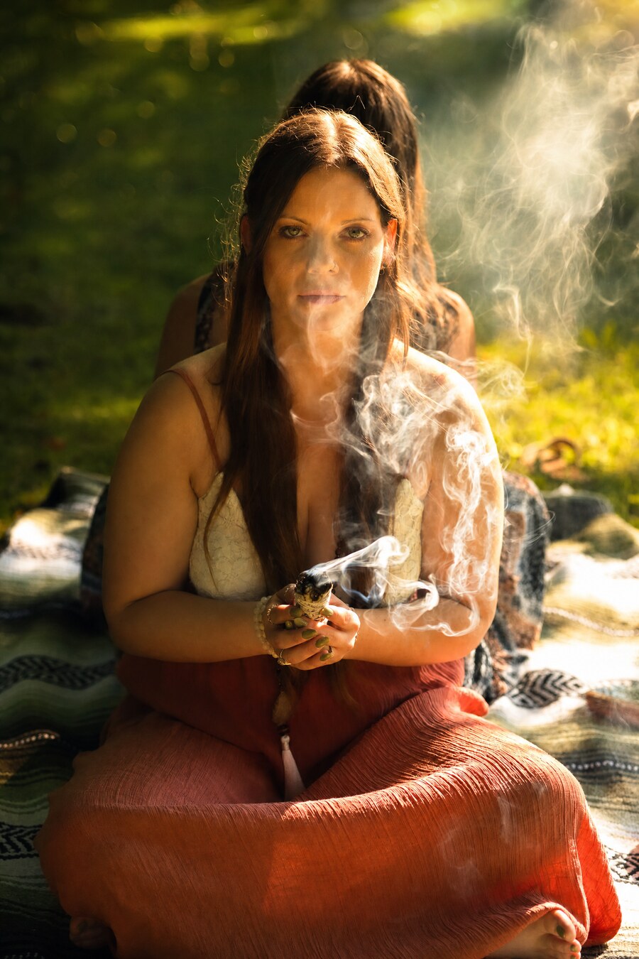 Zen Collection co-founder Samantha holding a cleansing bundle outdoors