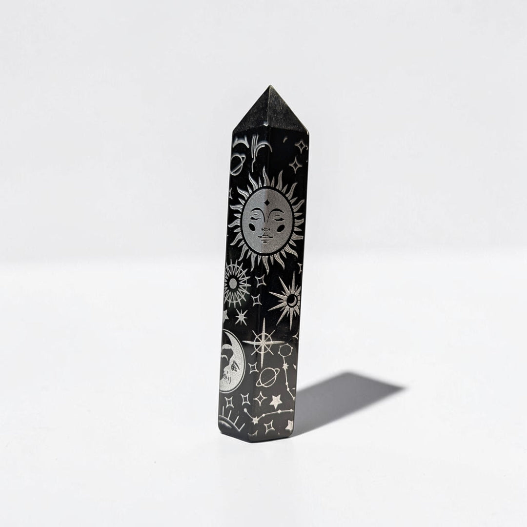 Zen Collection black obsidian crystal tower featuring intricate silver celestial engravings of sun, moon, and stars.