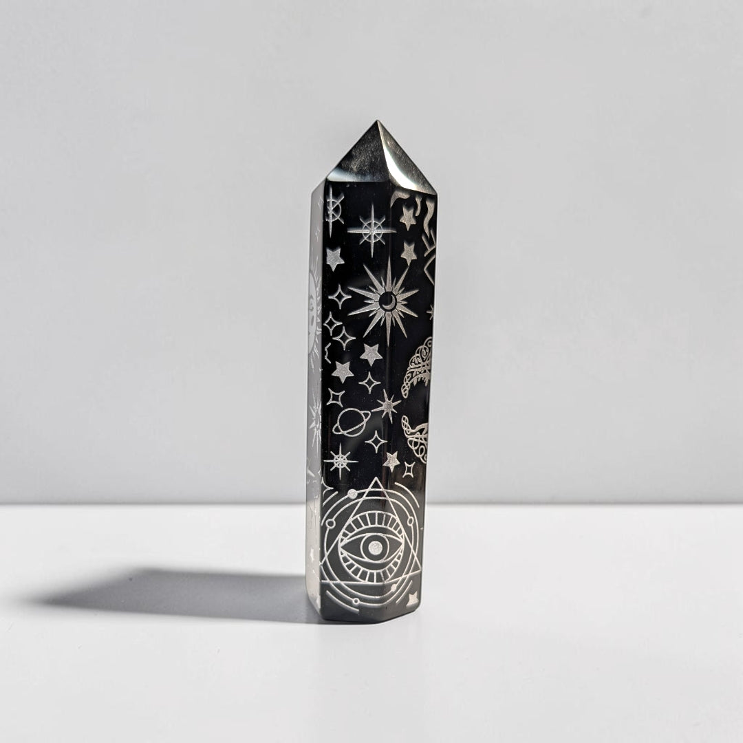 Zen Collection black obsidian crystal tower featuring intricate silver engraved celestial and mystical symbols.