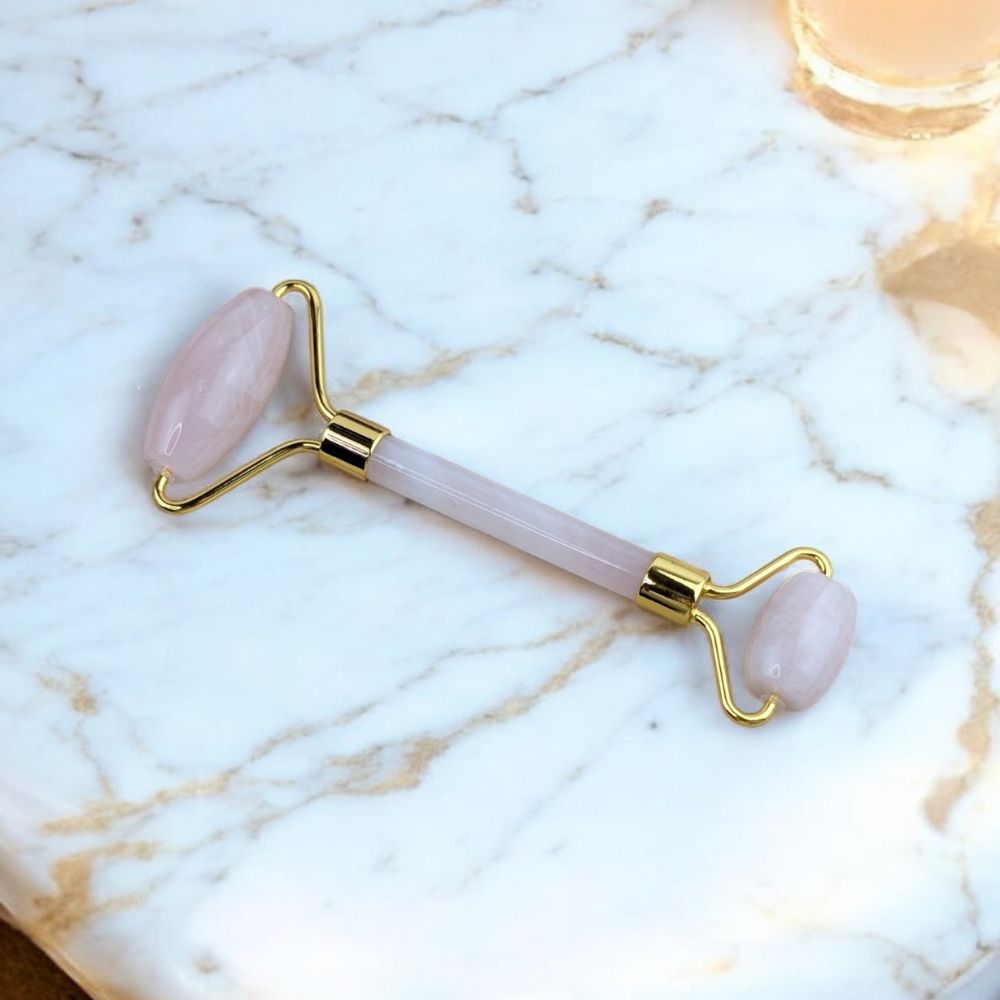 Close-up of soft pink Rose Quartz Facial Roller - Zen Collection