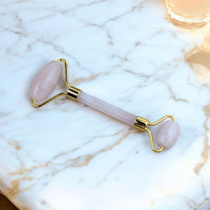 Close-up of soft pink Rose Quartz Facial Roller - Zen Collection
